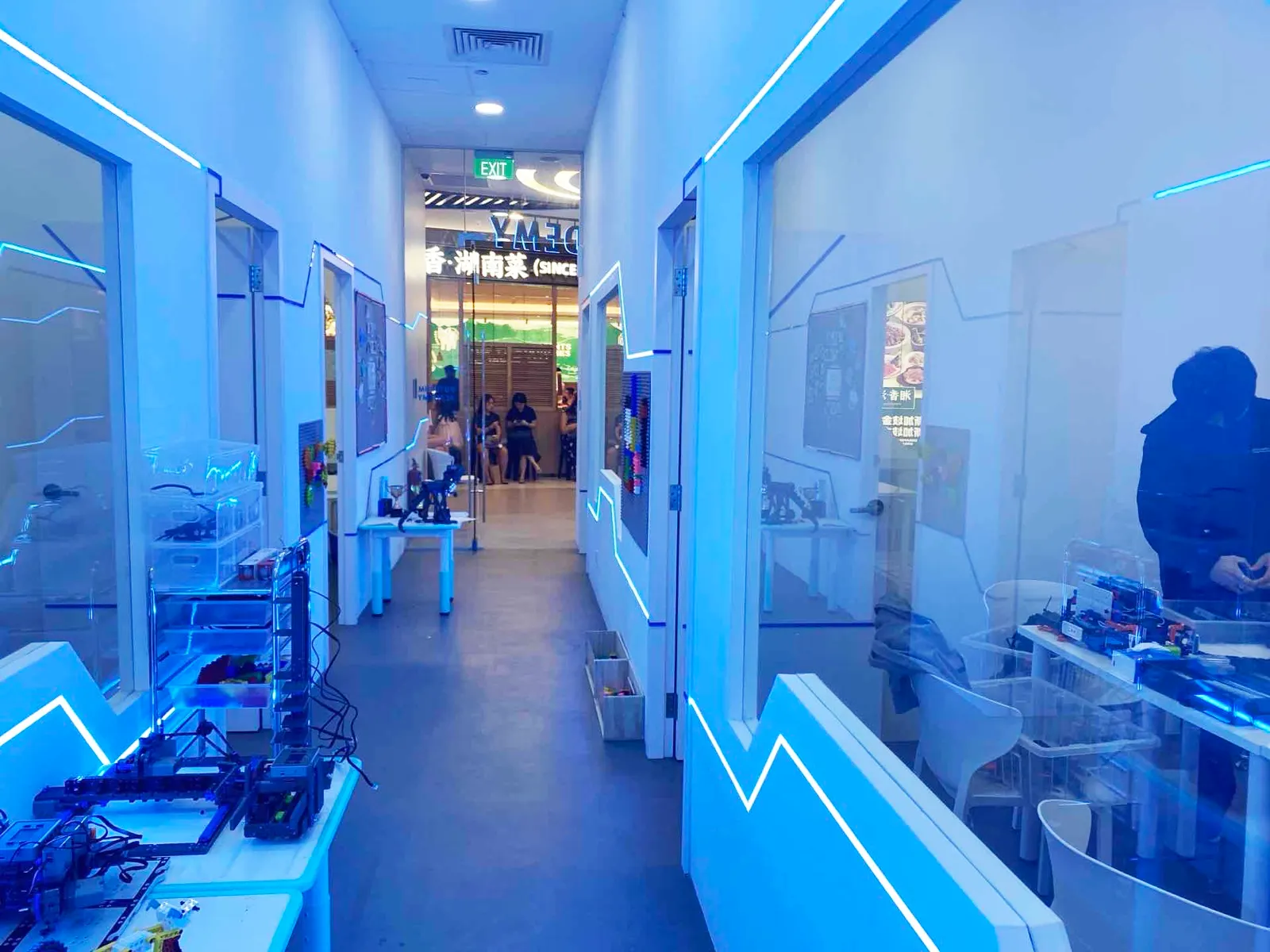 The blue LED robotics classroom corridor at an OpenKids campus