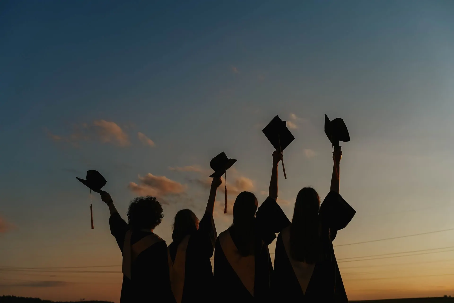 A graduate backlit by golden light, ready to launch